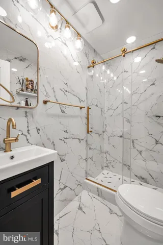 a bathroom with a sink toilet and shower