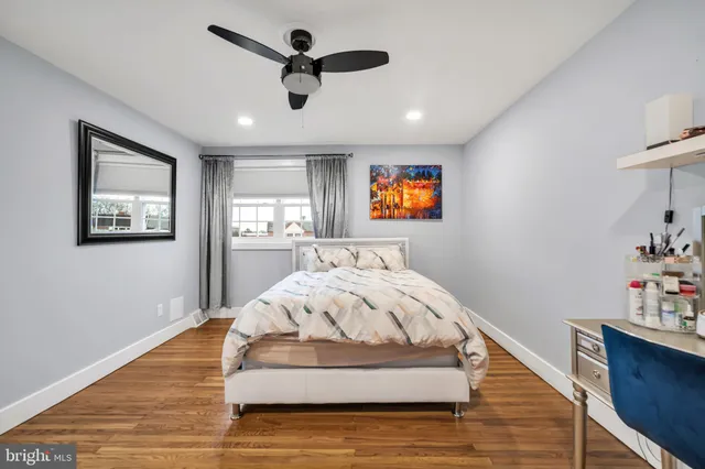 a spacious bedroom with a bed and a flat screen tv