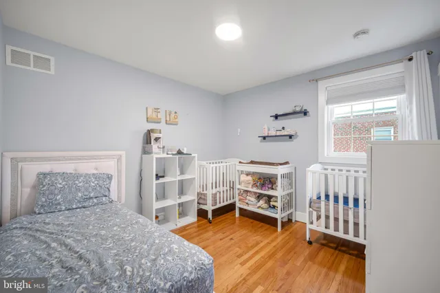 a bedroom with furniture and a wooden floor