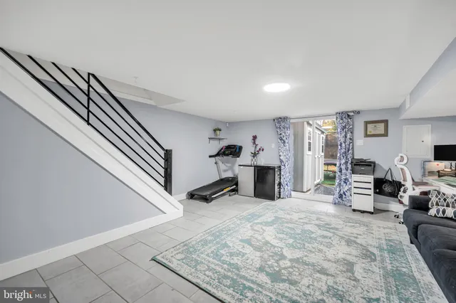 a view of a living room with furniture and a flat screen tv