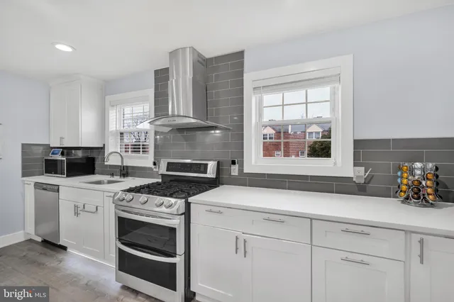 a kitchen with cabinets appliances and a window