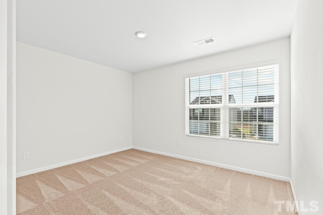 533 Crackling Court Zebulon, NC 27597 - Photo 13 of 14 a view of an empty room with a window
