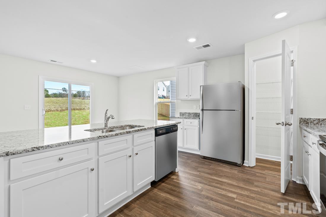533 Crackling Court Zebulon, NC 27597 - Photo 2 of 14 a kitchen with a refrigerator and a sink