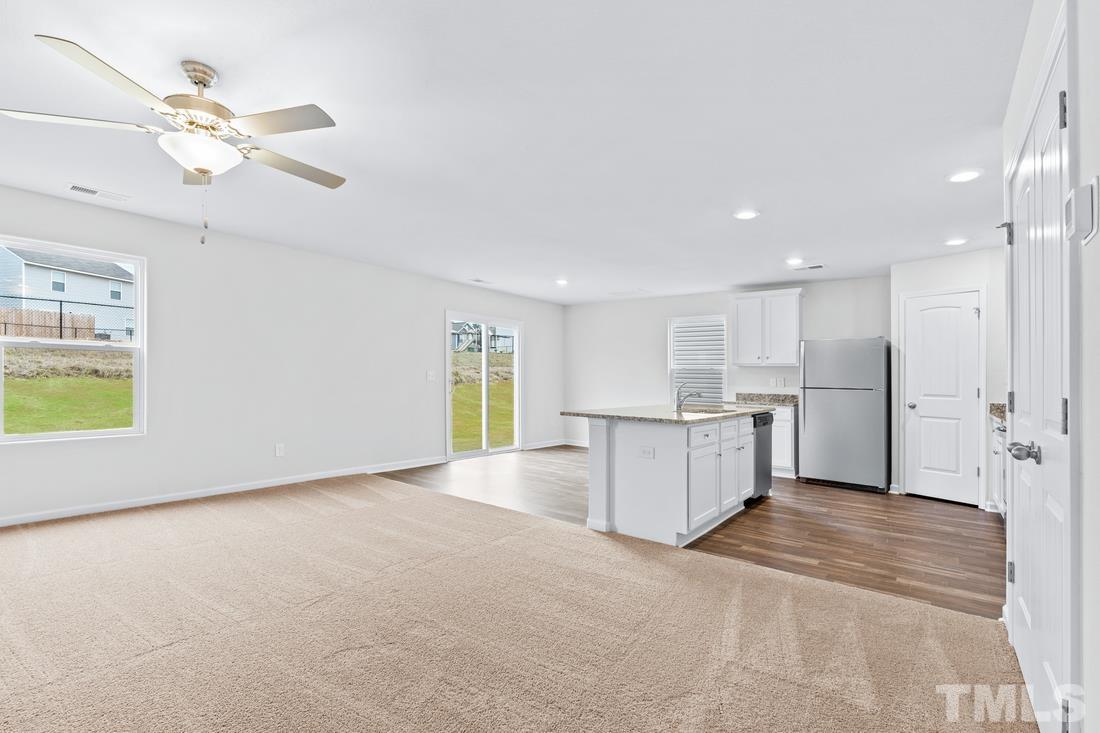 533 Crackling Court Zebulon, NC 27597 - Photo 7 of 14 a view of a kitchen with furniture and a kitchen