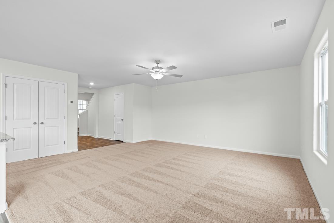 533 Crackling Court Zebulon, NC 27597 - Photo 8 of 14 wooden floor in an empty room with a window