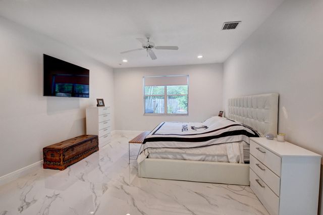 a bedroom with furniture and a flat screen tv