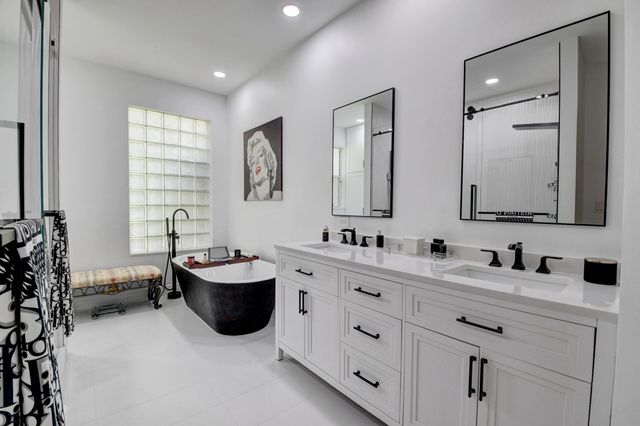 a en suite bathroom with double sink and a mirror