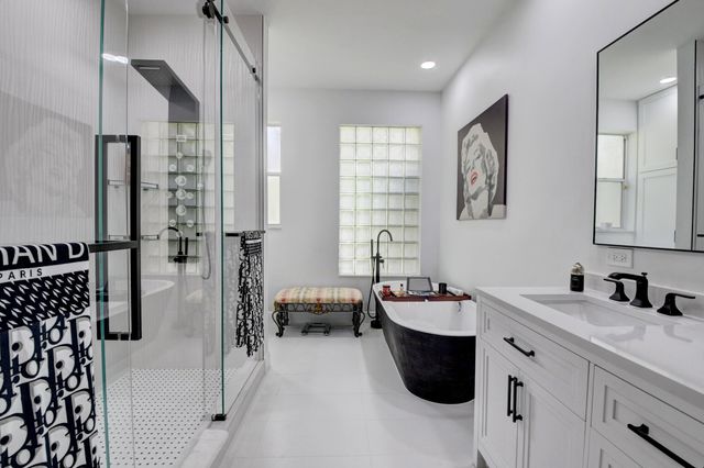 a bathroom with a double vanity sink mirror and shower