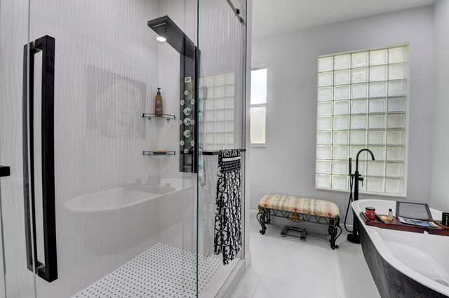 a bathroom with a tub and a shower