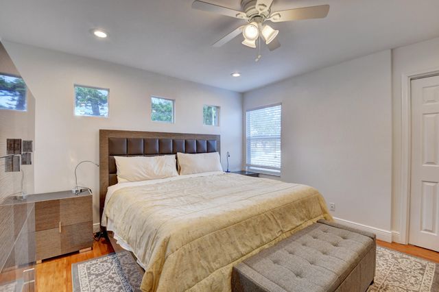 a bedroom with a large bed and a chandelier