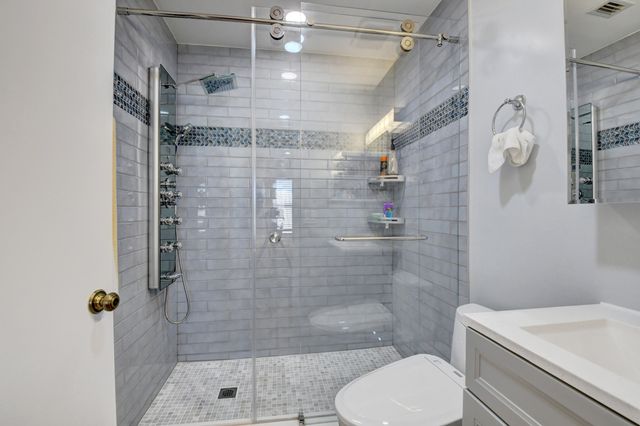 a bathroom with a shower and toilet