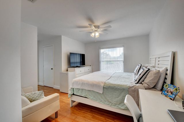 a bedroom with a bed and a television