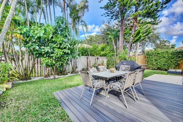 a view of a backyard with table and chairs