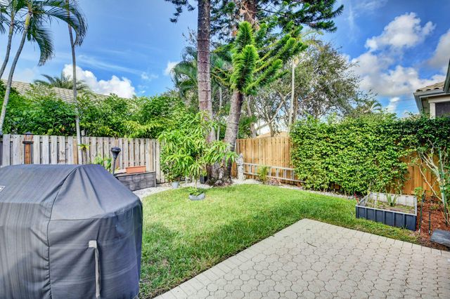 a view of a wooden dinning table and chairs in patio
