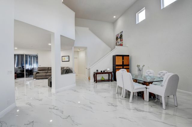 a dining room with furniture and window