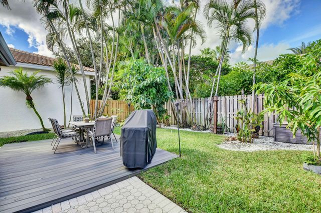 a view of a table and chairs in patio with wooden fence