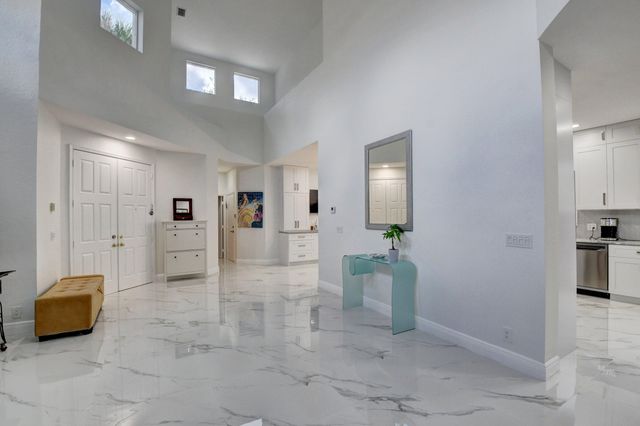 a view of a livingroom with furniture and a chandelier