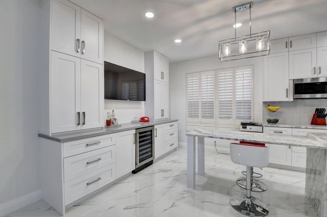 a kitchen with stainless steel appliances a stove a sink and a refrigerator