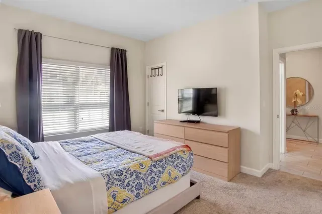 a bedroom with a bed and a television