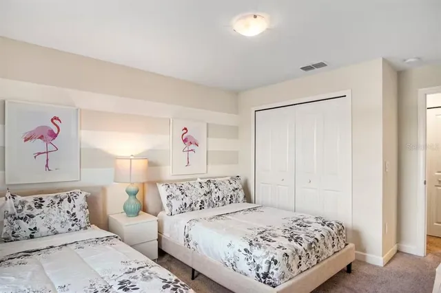 a bedroom with a bed and a painting on the wall