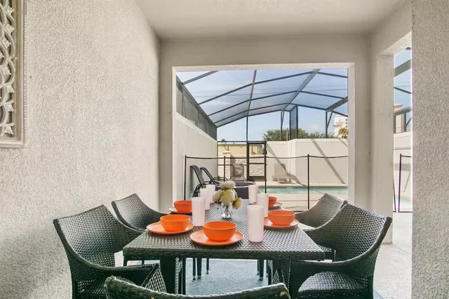 a view of a patio with a table and chairs under an umbrella with a fire pit