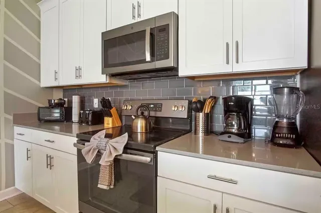 a kitchen with stainless steel appliances granite countertop a sink and cabinets