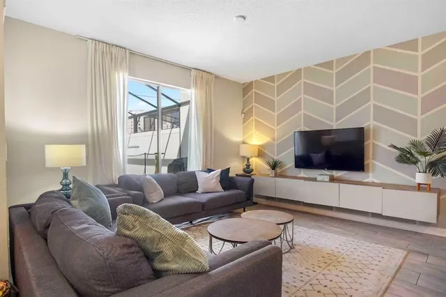 a living room with furniture and a flat screen tv