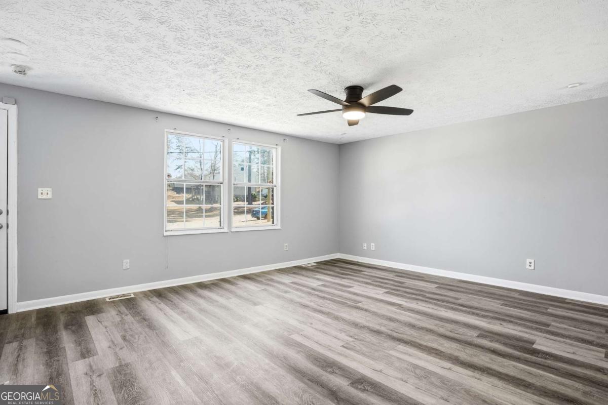 3579 Bramblevine Circle Lithonia, GA 30038 - Photo 4 of 25 wooden floor in an empty room with a window