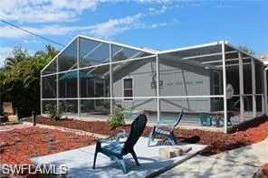 a backyard of a house with table and chairs