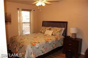 a large bed sitting in a bedroom next to a window