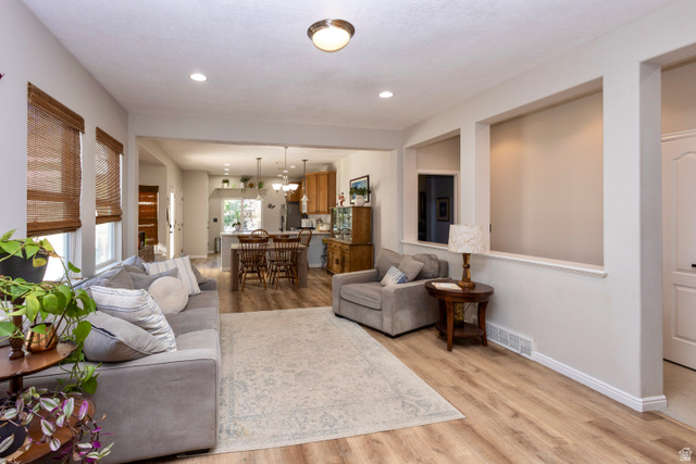 11751 Lake Run Road South Jordan, UT 84009 - Photo 10 of 38 Open-concept interior featuring wood-finish flooring, recessed lighting, and light neutral wall colors