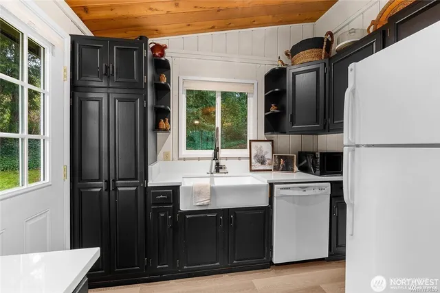 a kitchen with a sink and a refrigerator