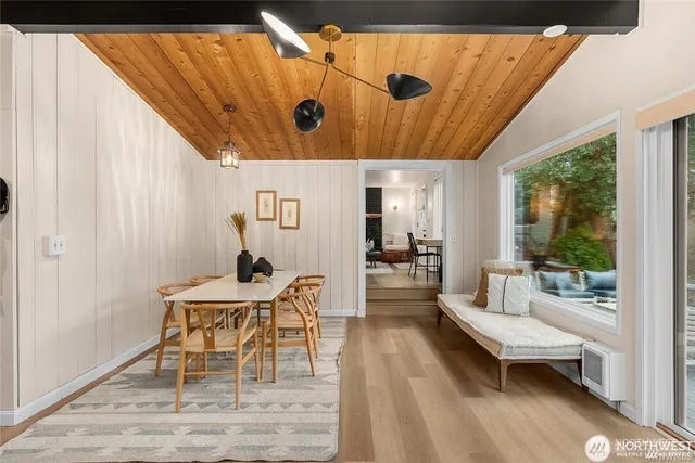 a dining room with furniture and wooden floor