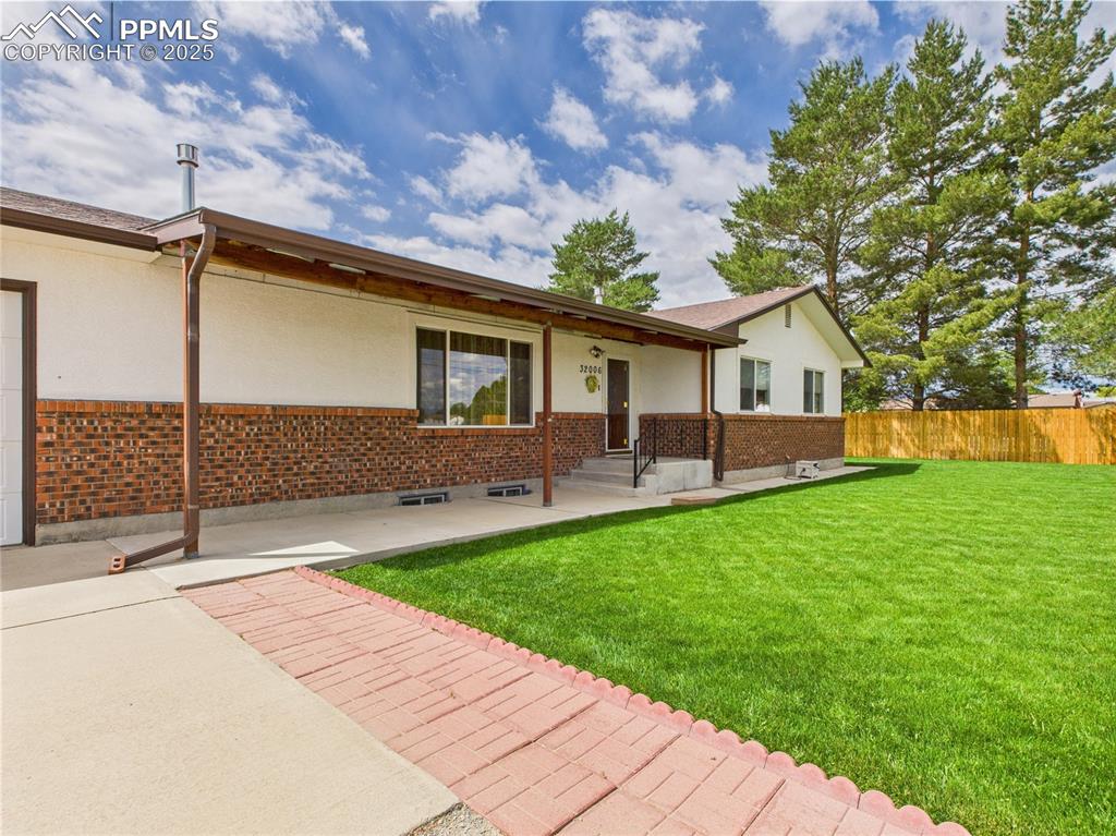 32006 Ford Road Pueblo, CO 81006 - Photo 12 of 50 a front view of a house with a garden and yard