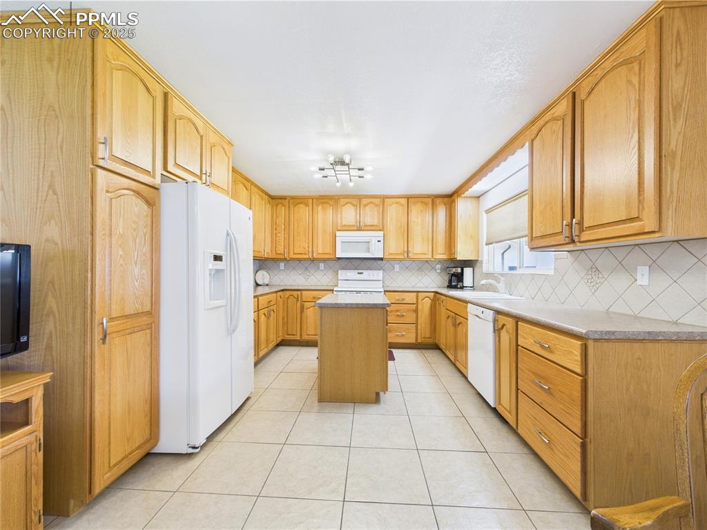 32006 Ford Road Pueblo, CO 81006 - Photo 18 of 50 a large kitchen with stainless steel appliances granite countertop a sink and cabinets