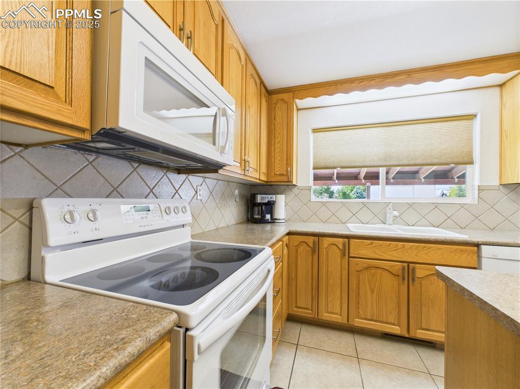 32006 Ford Road Pueblo, CO 81006 - Photo 21 of 50 a kitchen that has a sink and a stove
