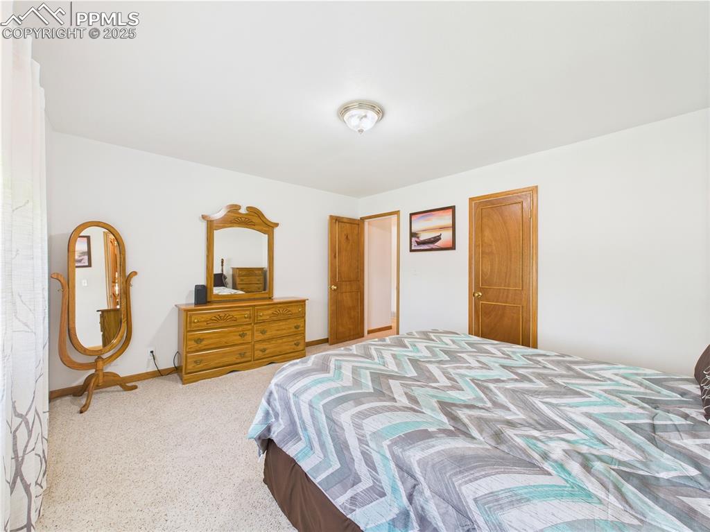 32006 Ford Road Pueblo, CO 81006 - Photo 29 of 50 a bedroom with a bed and dresser with mirror