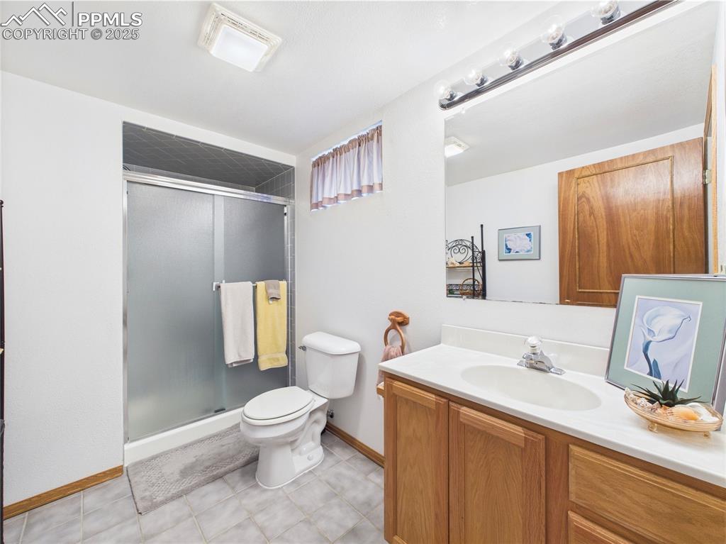 32006 Ford Road Pueblo, CO 81006 - Photo 45 of 50 a bathroom with a sink a toilet and a large mirror