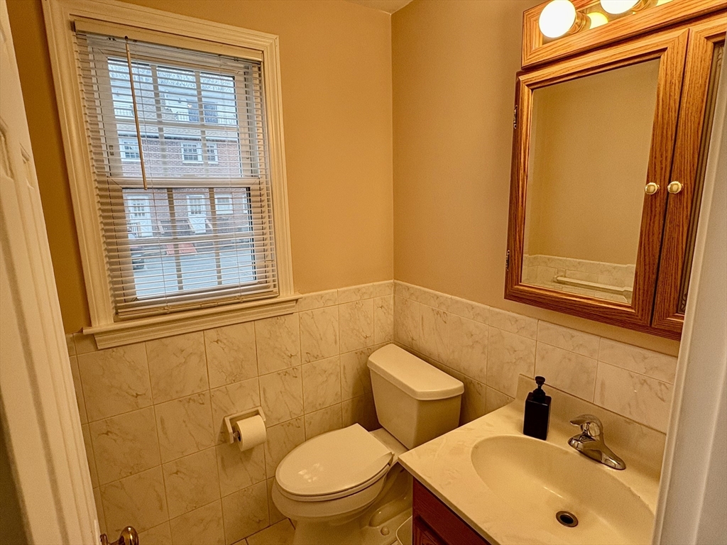 224 Park Street, Unit B2 Stoneham, MA 02180 - Photo 12 of 35 a bathroom with a toilet sink and mirror