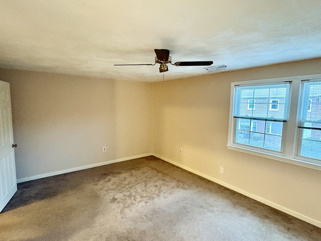 224 Park Street, Unit B2 Stoneham, MA 02180 - Photo 19 of 35 an empty room with windows