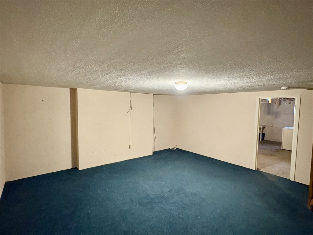 224 Park Street, Unit B2 Stoneham, MA 02180 - Photo 29 of 35 an empty room with a bench