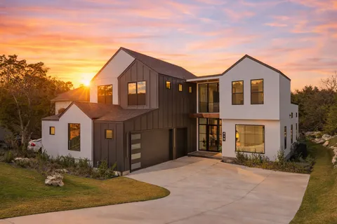 a living room with furniture a ceiling fan and a large window