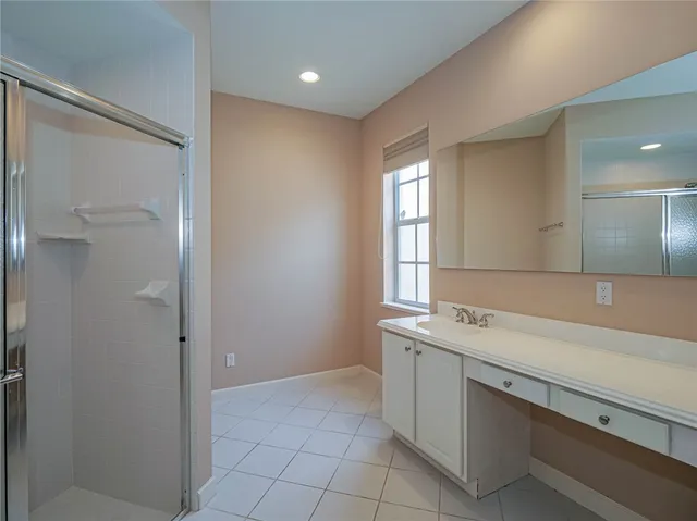 a bathroom with a glass shower door