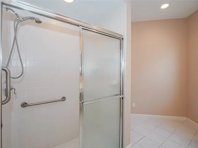 an empty room with a window and chandelier