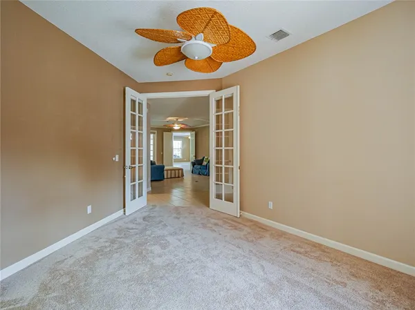 an empty room with a window and a chandelier