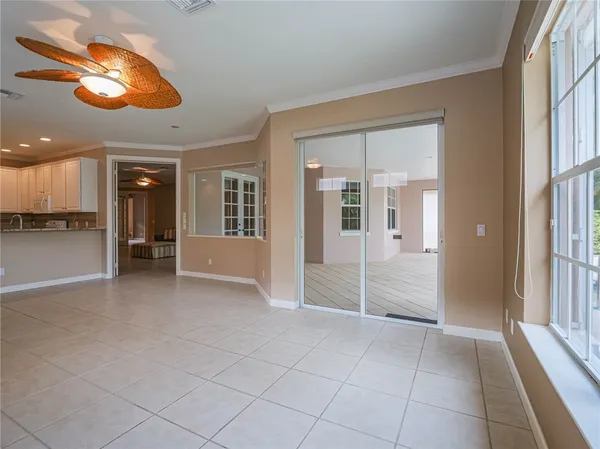 an empty room with kitchen view and a window