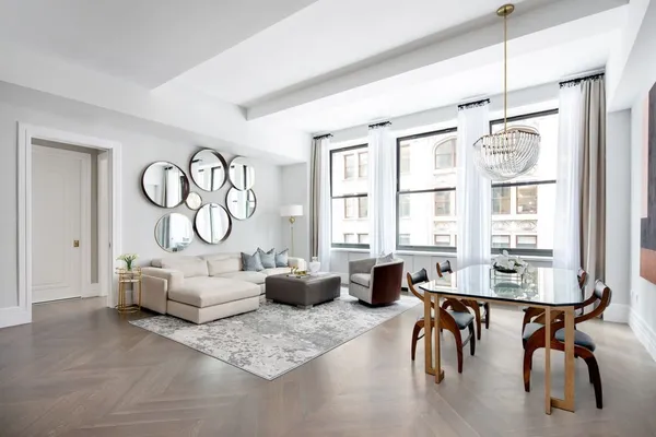 a living room with furniture a window and a table