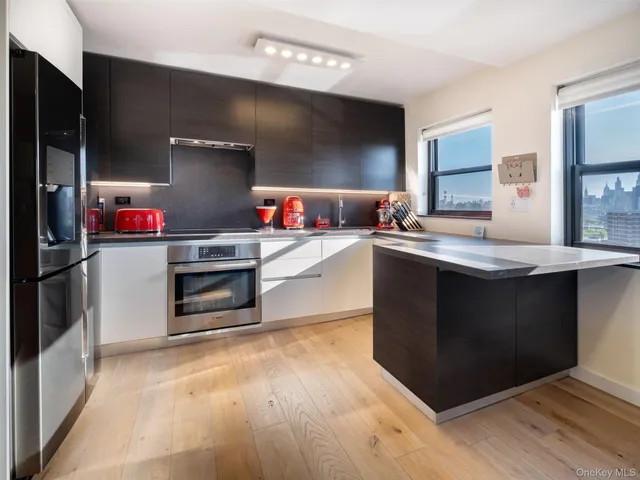 a kitchen with kitchen island cabinets a sink and a stove