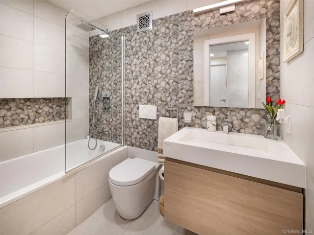 a bathroom with a sink a toilet and bathtub