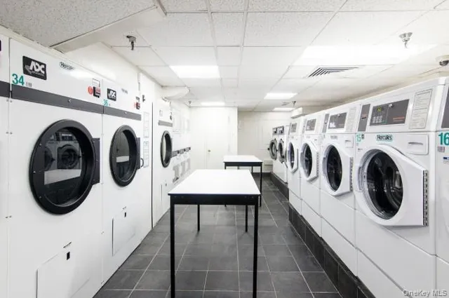 a view of a tennis ground with large trees